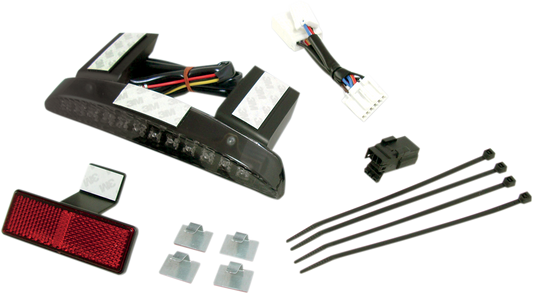 DRAG SPECIALTIES running and brake light assembly with smoke lens for motorcycle, featuring sleek black design and clear lens.