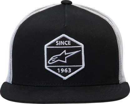 Alpinestars Bolt Trucker Hat in black and white with logo patch, featuring mesh back and adjustable snap closure.
