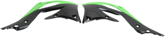 A set of ACERBIS radiator shrouds in green and black for motorcycle body protection, featuring aerodynamic design and branding.