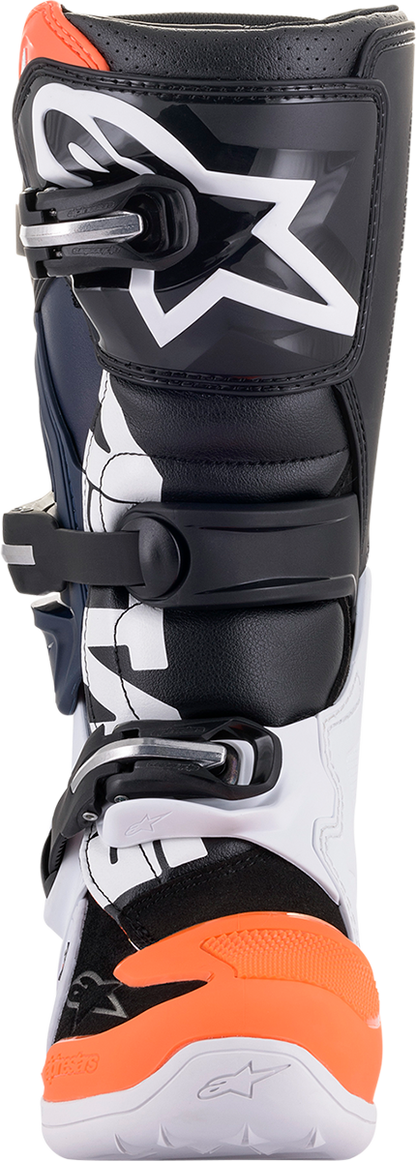 Alpinestars Youth Tech 7S motorcycle boots in black, orange, and white with sturdy construction and adjustable straps.