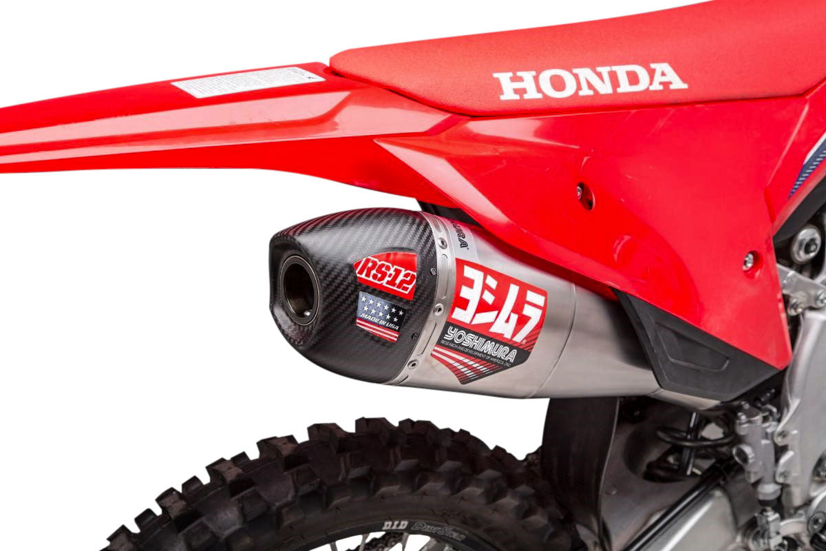 YOSHIMURA RS-12 slip-on exhaust system for dirt bikes, featuring a sleek metal muffler with branded logo and mounting components.