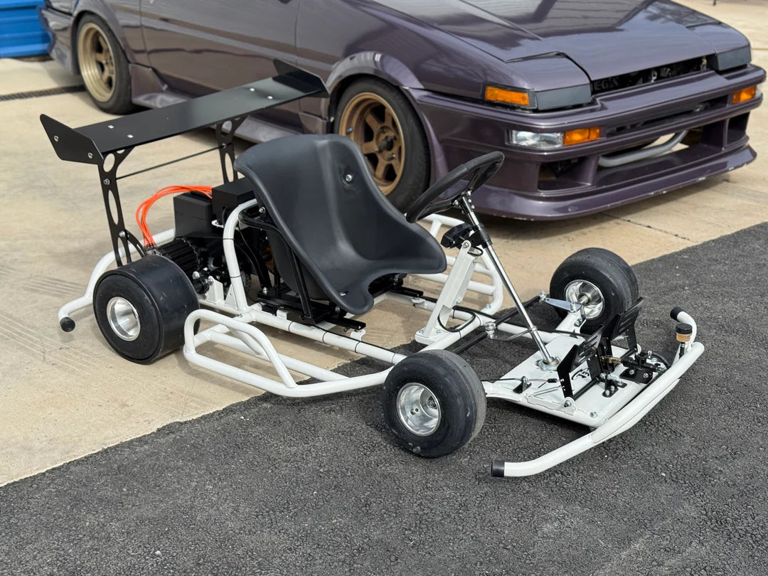 Electro & Co ETM E-Drift Kart, an electric drift go-kart, shown on a smooth track with racing wheels and sleek design.