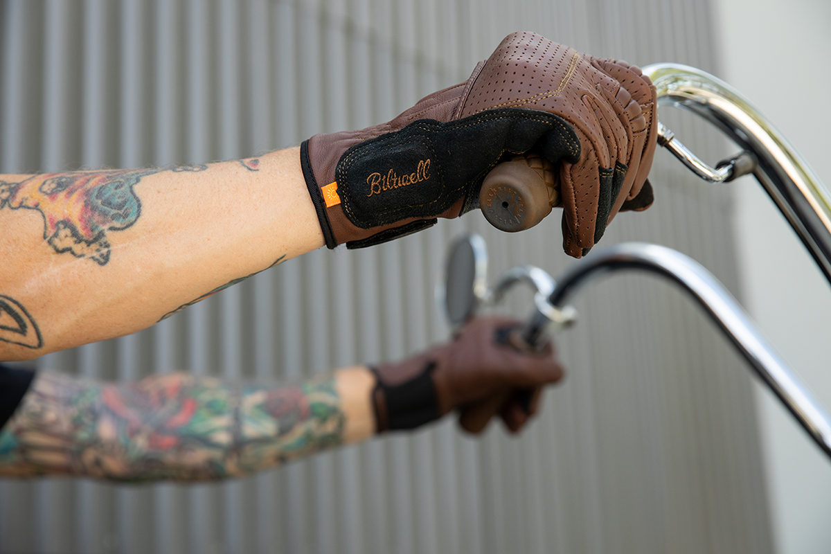 BILTWELL Borrego Gloves in chocolate and black, large size, showing textured leather exterior and secure wrist strap detail.