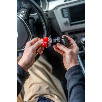 SP CONNECT charging mount with adhesive base attached to a surface, designed for secure smartphone mounting and charging.