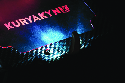 Kuryakyn LED license plate light in black for powersports vehicles, mounted on a motorcycle or ATV.