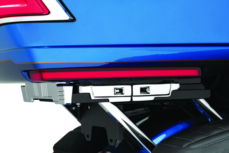 Kuryakyn Tracer Tour Pak side lights with red lens installed on Harley Davidson touring motorcycle for enhanced visibility.