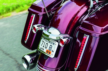 Chrome Kuryakyn curved license plate mount for Harley-Davidson Street Glide and Road Glide motorcycles, part #3157.