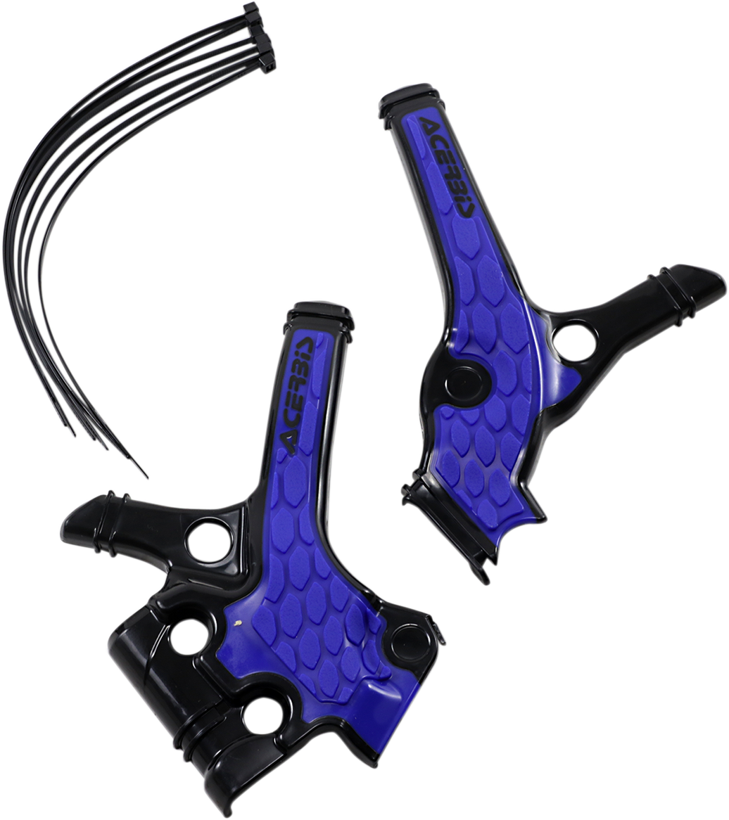 A close-up of ACERBIS X-Grip black and blue motorcycle frame guards showing textured body protection on a bike.