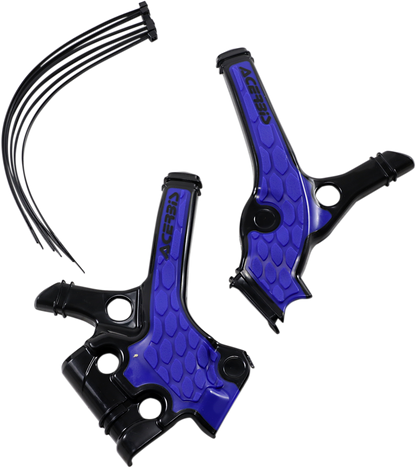 A close-up of ACERBIS X-Grip black and blue motorcycle frame guards showing textured body protection on a bike.