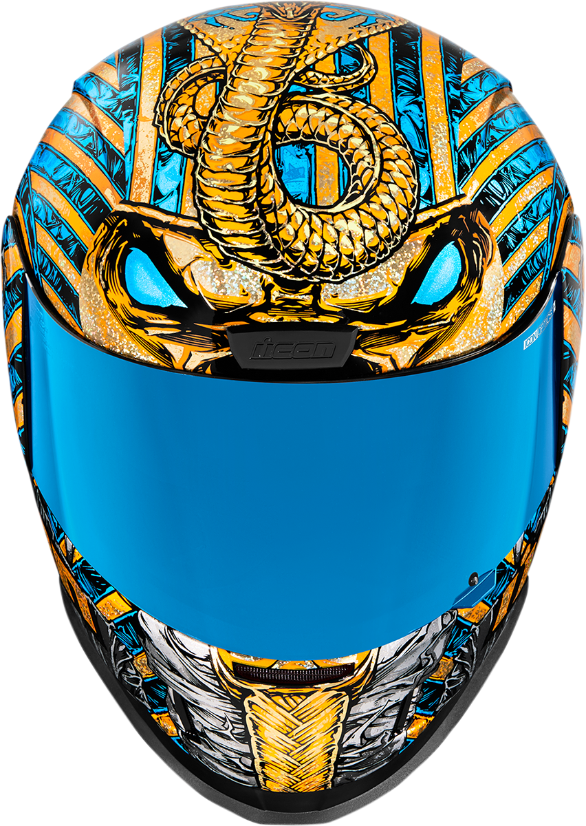 Gold ICON Airform™ Pharaoh helmet in medium size, featuring a sleek design and detailed graphics, suitable for motorcycle riders.
