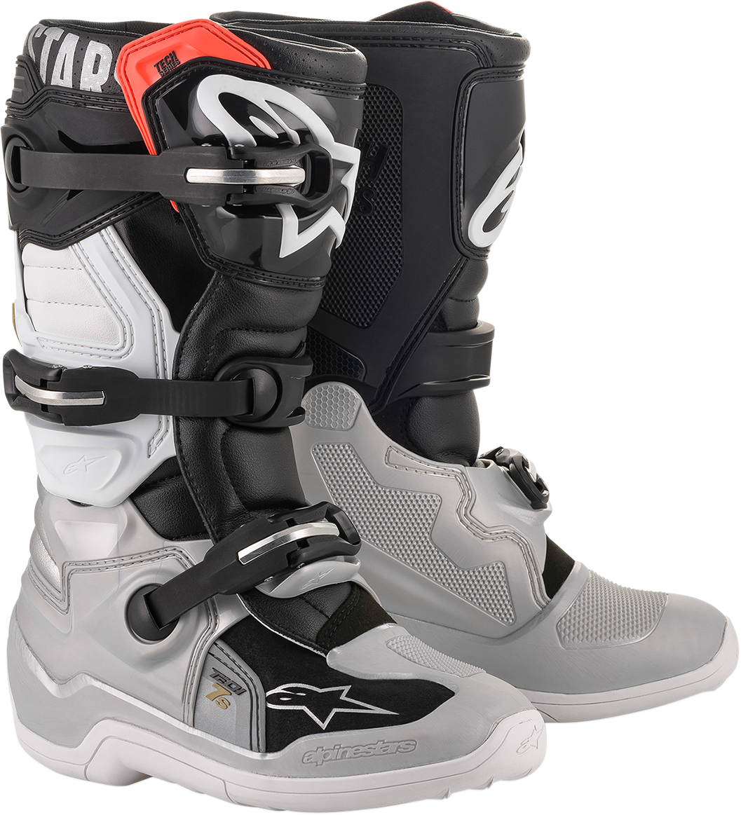 Alpinestars Tech 7S motorcycle boots in black, silver, white, and gold with sturdy design and ankle protection.
