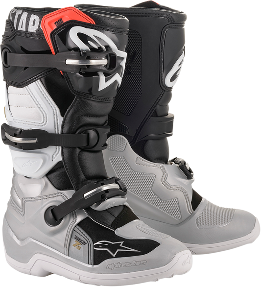 Alpinestars Tech 7S motorcycle boots in black, silver, white, and gold with sturdy design and ankle protection.
