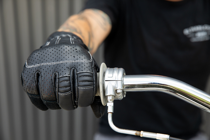 Black and cement-colored BILTWELL Borrego Gloves by Bill's Exhausts in medium size, showing the textured leather and secure wrist closure.