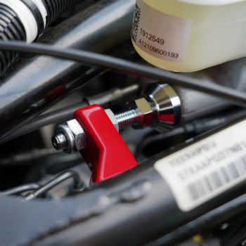Chrome master cylinder brace for Harley Davidson, shows the shiny metal bracket with mounting holes and red accents, labeled SHOW CHROME.