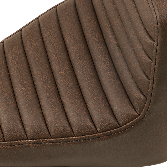 Brown SADDLEMEN Step Up Seat with front tuck-n-roll and rear lattice stitch, designed for motorcycle comfort and style.