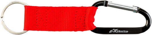 Red Alpinstars key fob snap hook, a durable protective gear accessory with a secure clip for key or gear attachment.