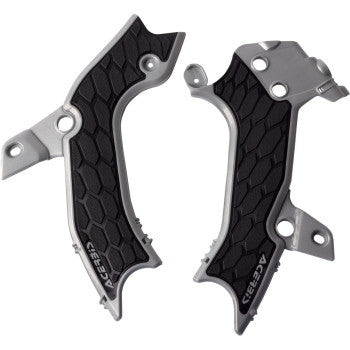 A close-up of Acerbis X-Grip frame guards in silver and black attached to a motocross bike frame.