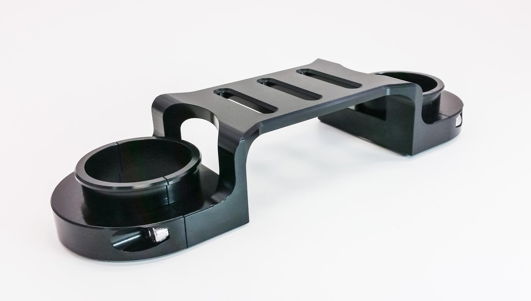 Black Suzuki DR650 fork brace by Warp9Racing, designed for enhanced stability and protection on the motorcycle.