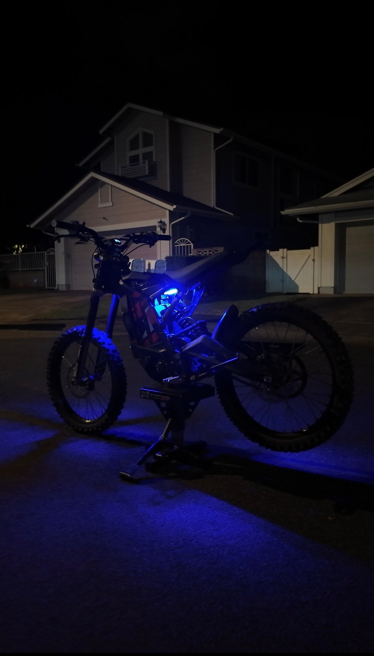 Blue rear underglow kit for Talaria MX4 and MX5 electric motorcycles by Project9, showing the illuminated blue undercarriage.