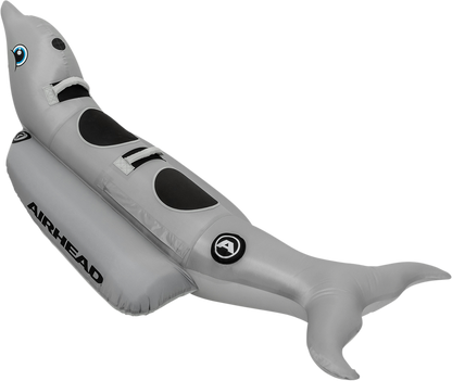 Dolphin riding tube from AIRHEAD SPORTS GROUP on water with a person riding, designed for towable water fun by Bill's Exhausts.