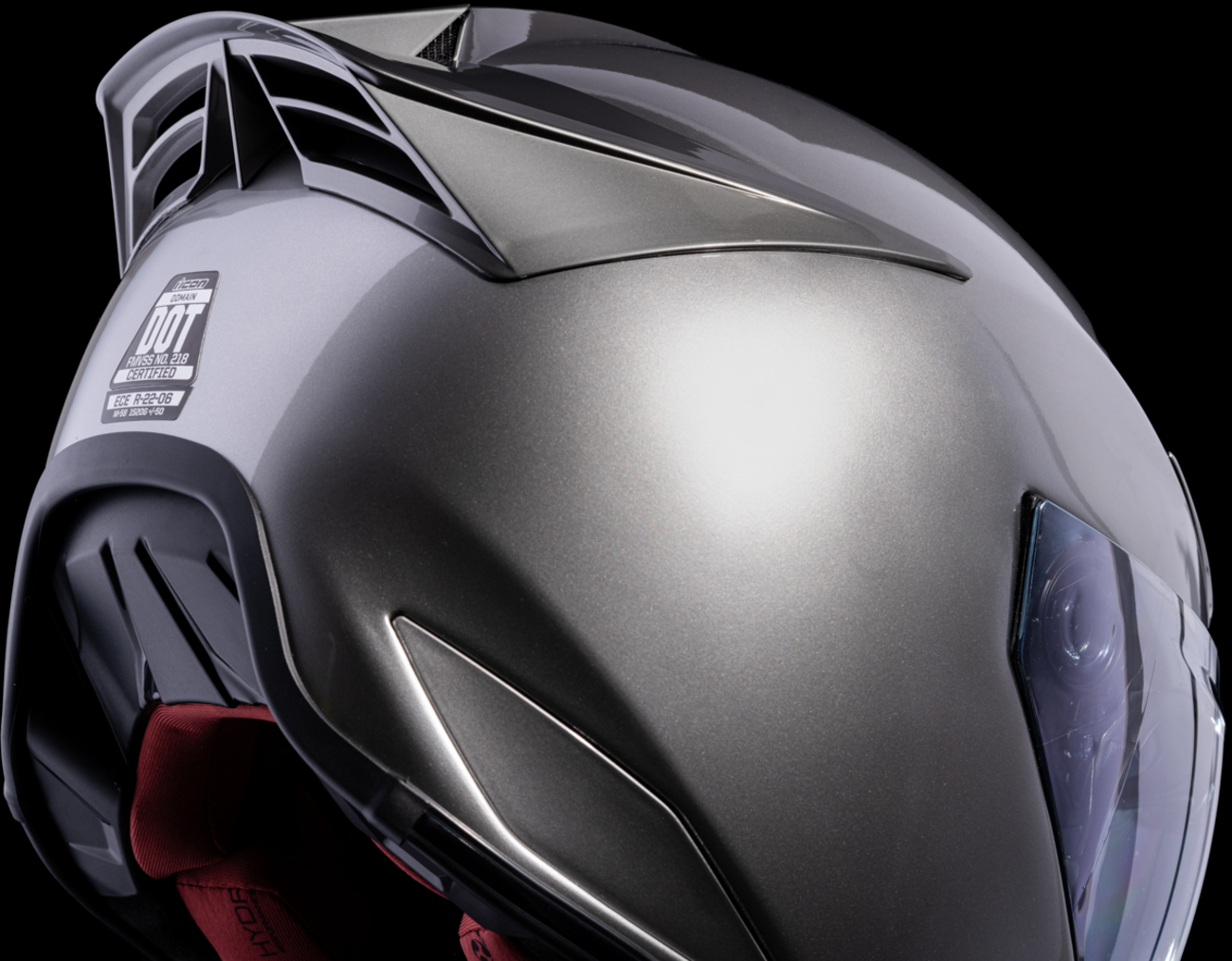 Silver ICON Domain™ Cornelius helmet in large size, featuring a sleek aerodynamic design and brand logo on the surface.