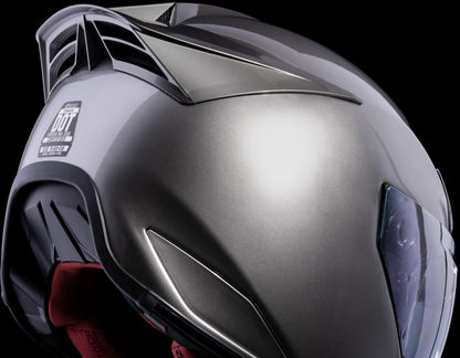 Silver ICON Domain™ Cornelius helmet in large size, featuring a sleek aerodynamic design and brand logo on the surface.