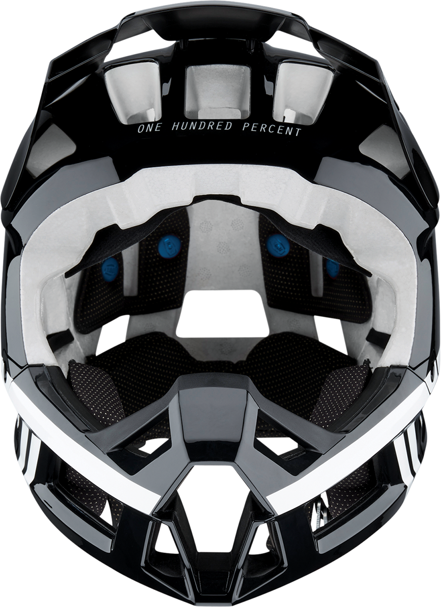 Black and white 100% Trajecta bicycle helmet with Fidlock buckle in XL size, featuring a sleek design and adjustable straps.