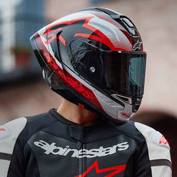 Alpinestars Supertech R10 Team helmet in black, carbon red, and gloss white with 2XL size, featuring aerodynamic design and vents.