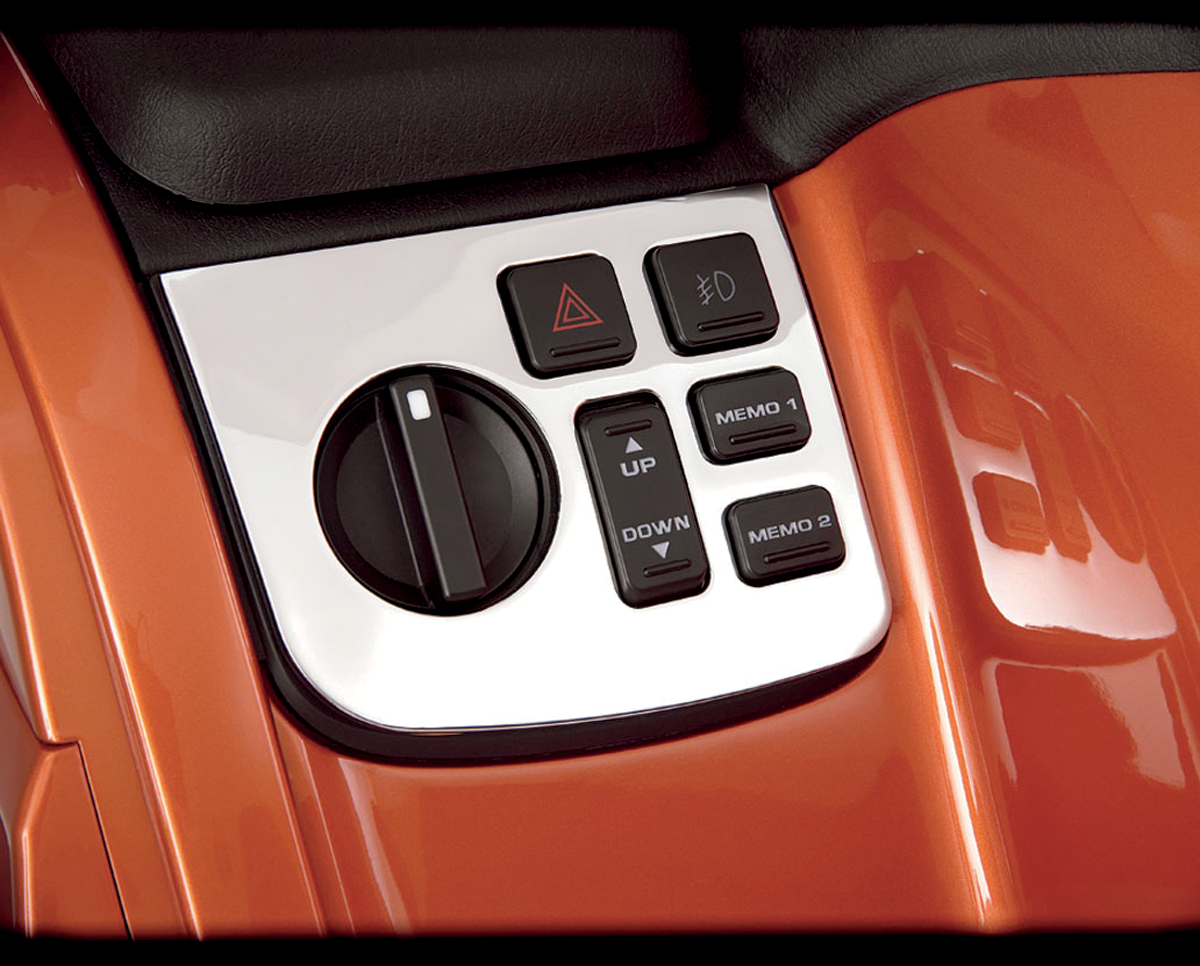 Chrome left control panel accent for engine from Bill's Exhausts, featuring a shiny, polished chrome finish with detailed design.