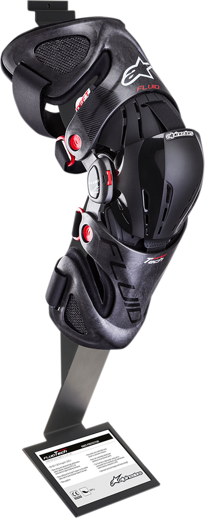 Alpinestars Fluid Knee Brace display bracket, black plastic support for motorcycle knee protection, shown on a white background.