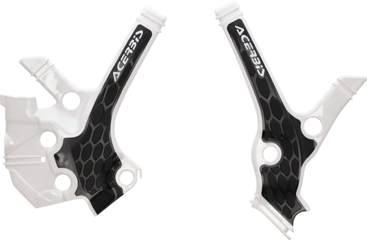A close-up of ACERBIS X-Grip motorcycle frame guards in white and black, designed for durable body protection.