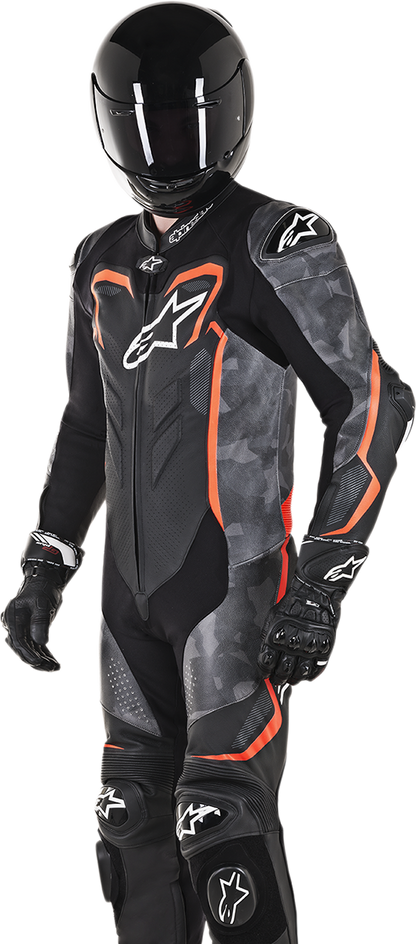 Alpinestars GP Plus v2 Camo black leather suit with red fluorescent accents, displayed on a mannequin.