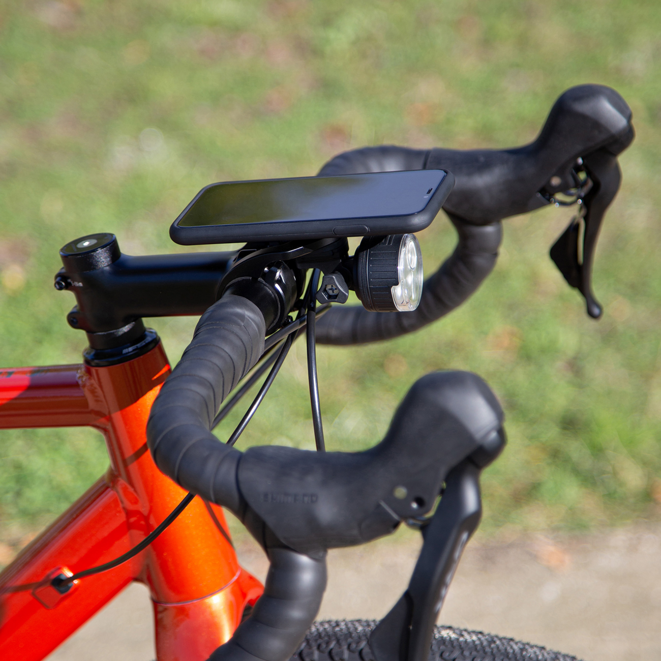 Bill's Exhausts SP CONNECT Adapter for Camera/Light phone attachment, shown mounted on a compatible smartphone.