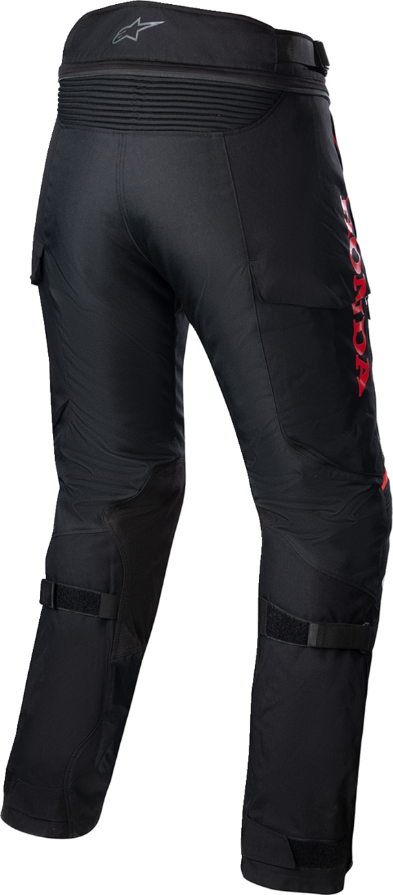 Black and red Alpinstars Honda Bogotà Pro Drystar motorcycle pants in medium size, showcasing durable riding gear with protective features.