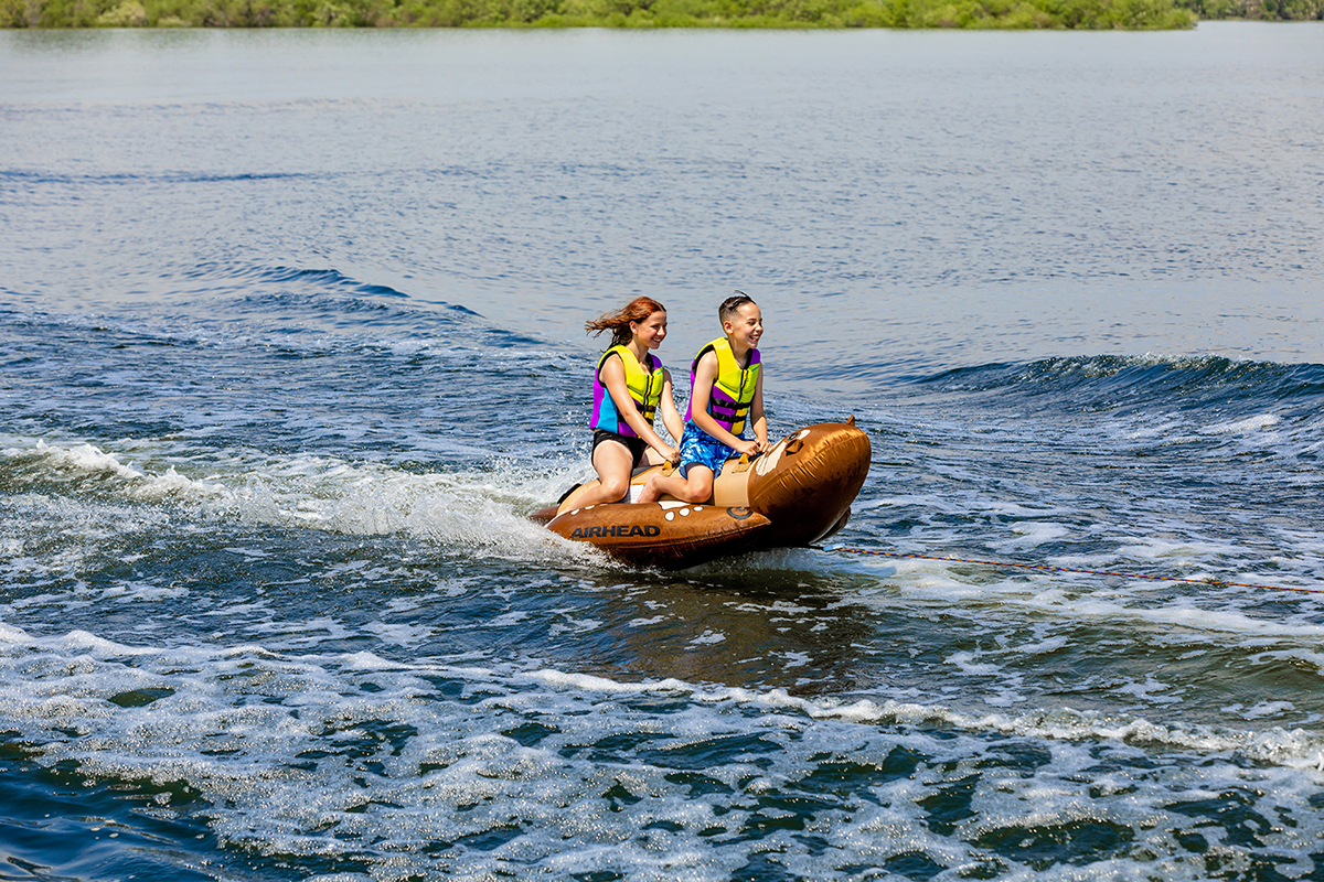 Bill's Exhausts Otter Riding Tube water toy from AIRHEAD SPORTS GROUP, featuring colorful inflatable design for tubing fun.