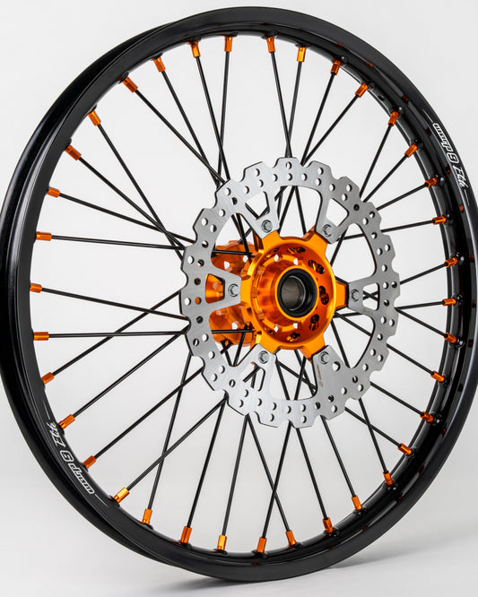 Warp9Racing front 21-inch wheel for KTM, Husqvarna, and Gas Gas bikes, showing the black wheel with spokes and rim detail.