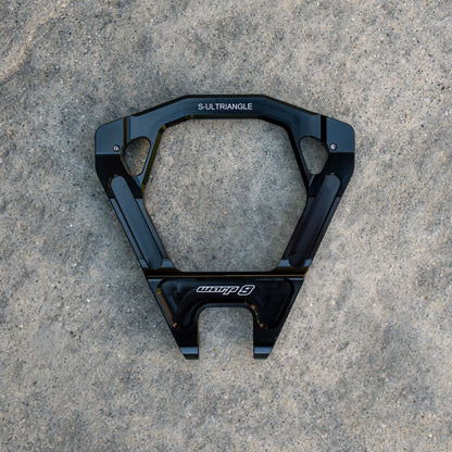 Close-up of Warp9Racing Surron Ultra Bee Triangles for electric bike modification, showing detailed metal components and mounting points.