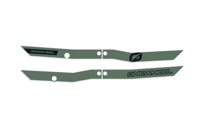 Dark olive Onewheel XR Classic Recurve Rail Guards installed on the skateboard's rails, showing a sleek protective design.
