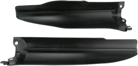 Black Acerbis lower fork covers for bikes, shown on a motorcycle's front suspension in a close-up view.
