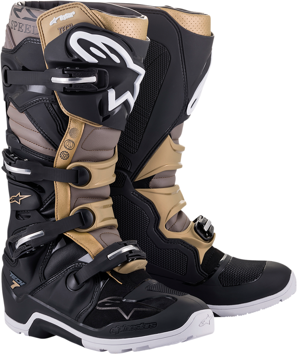 Alpinestars Tech 7 Enduro Drystar motorcycle boots in black, gray, and gold with sturdy design and protective features.