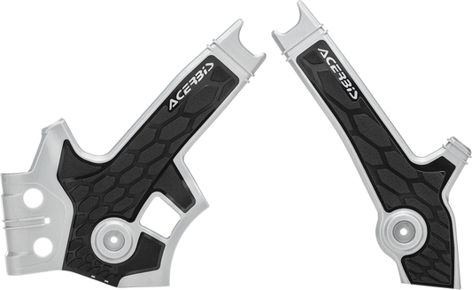 A set of silver and black Acerbis X-Grip motorcycle frame guards with body protection, designed for durable bike safeguarding.