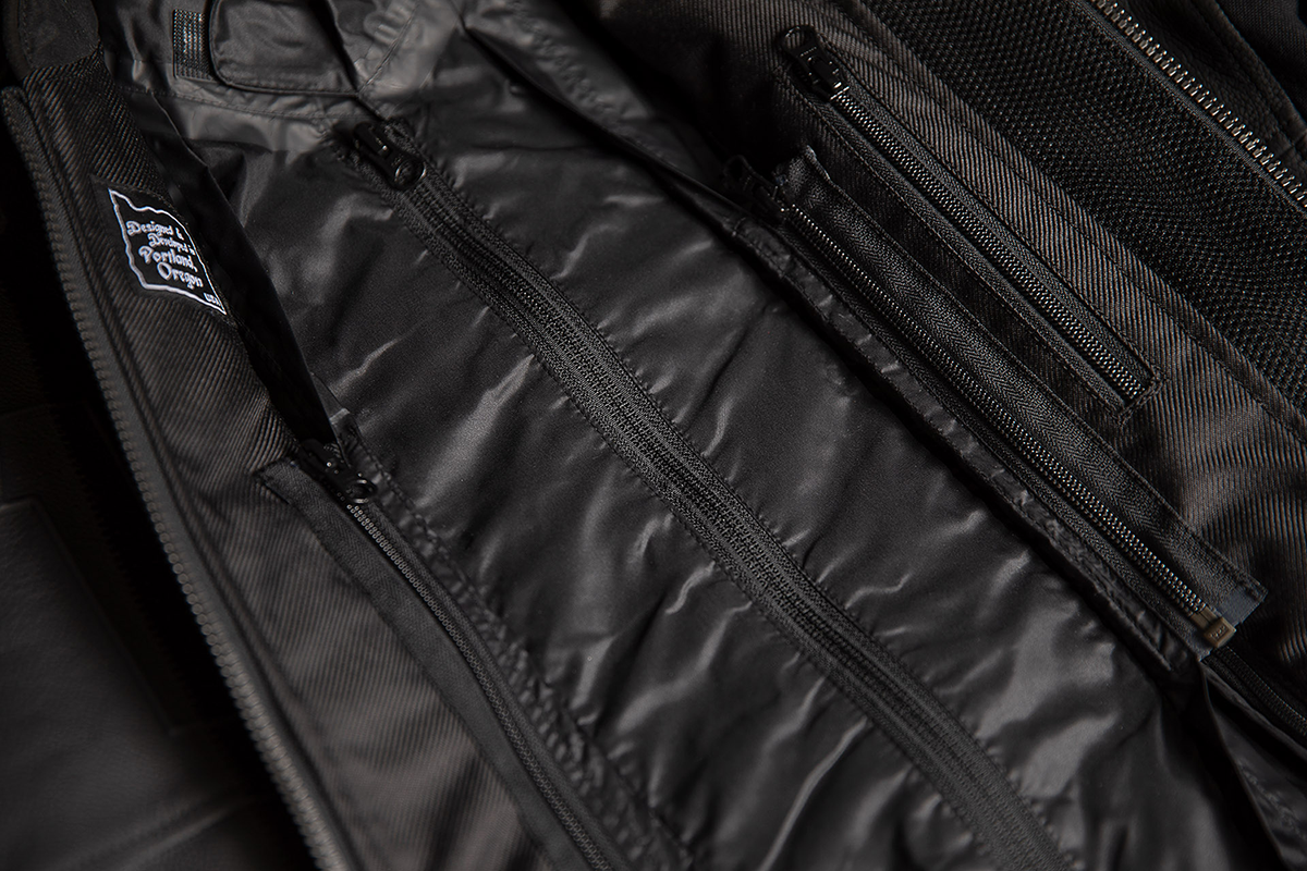 Black ICON Motorhead3™ jacket in large size with detailed stitching and logo, designed for motorcycle riders.