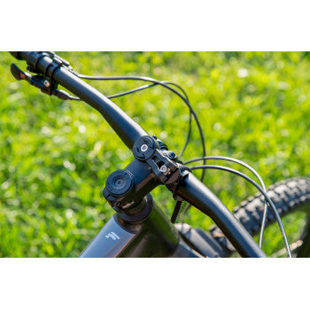 Universal SP CONNECT device mount by Bill's Exhausts attached to a motorcycle handlebar with a smartphone secured in place.