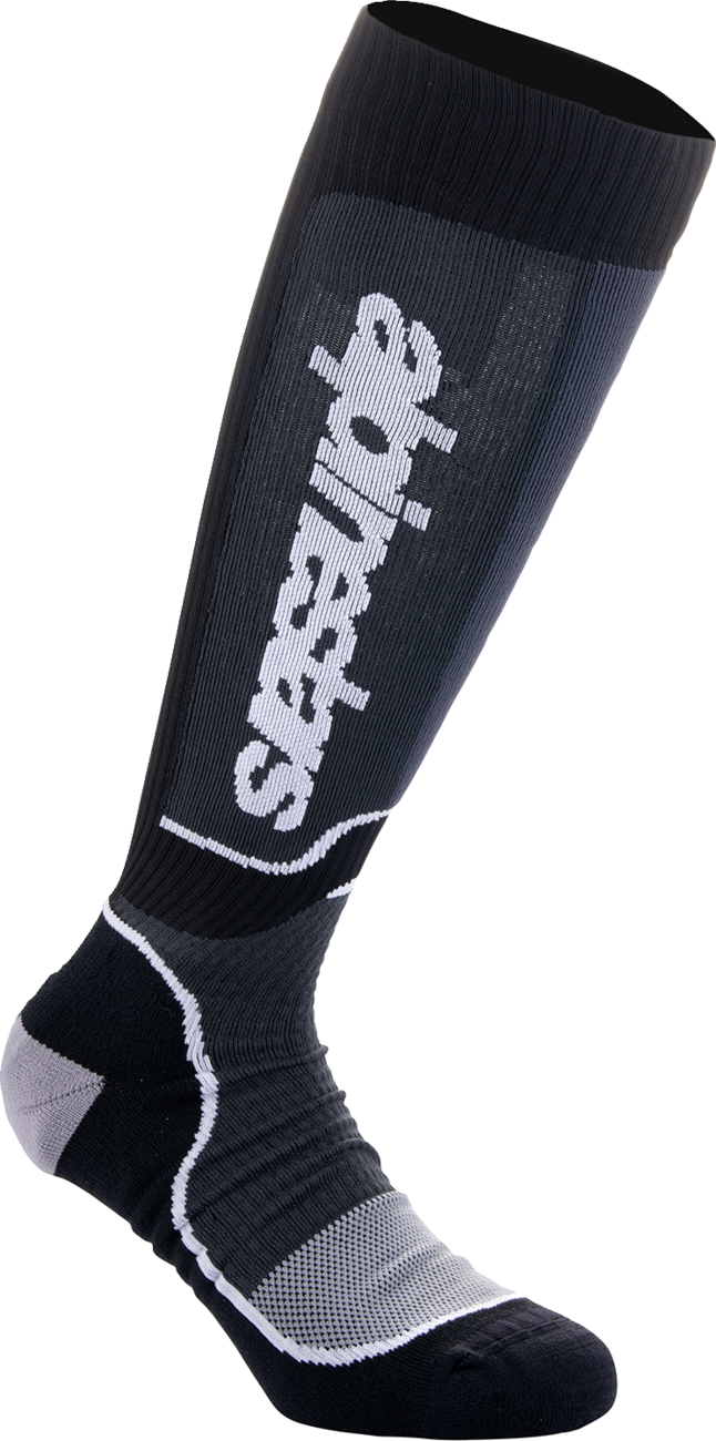 Alpinestars MX Plus motorcycle socks in black and white, medium size, featuring reinforced heel and toe for motocross riding comfort.