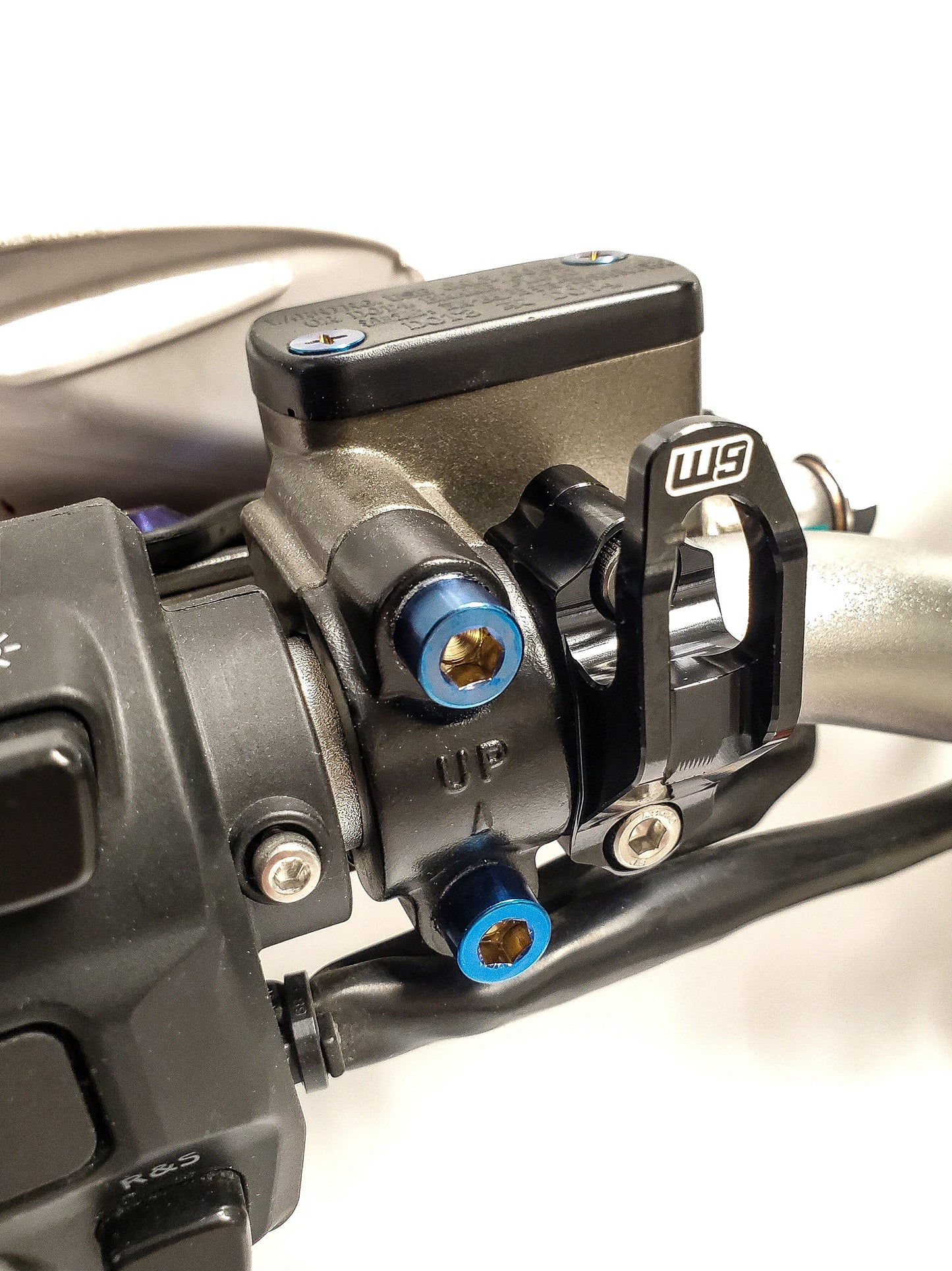 Warp9Racing helmet hook mounted on wall, sturdy metal motorcycle gear storage accessory for helmets.