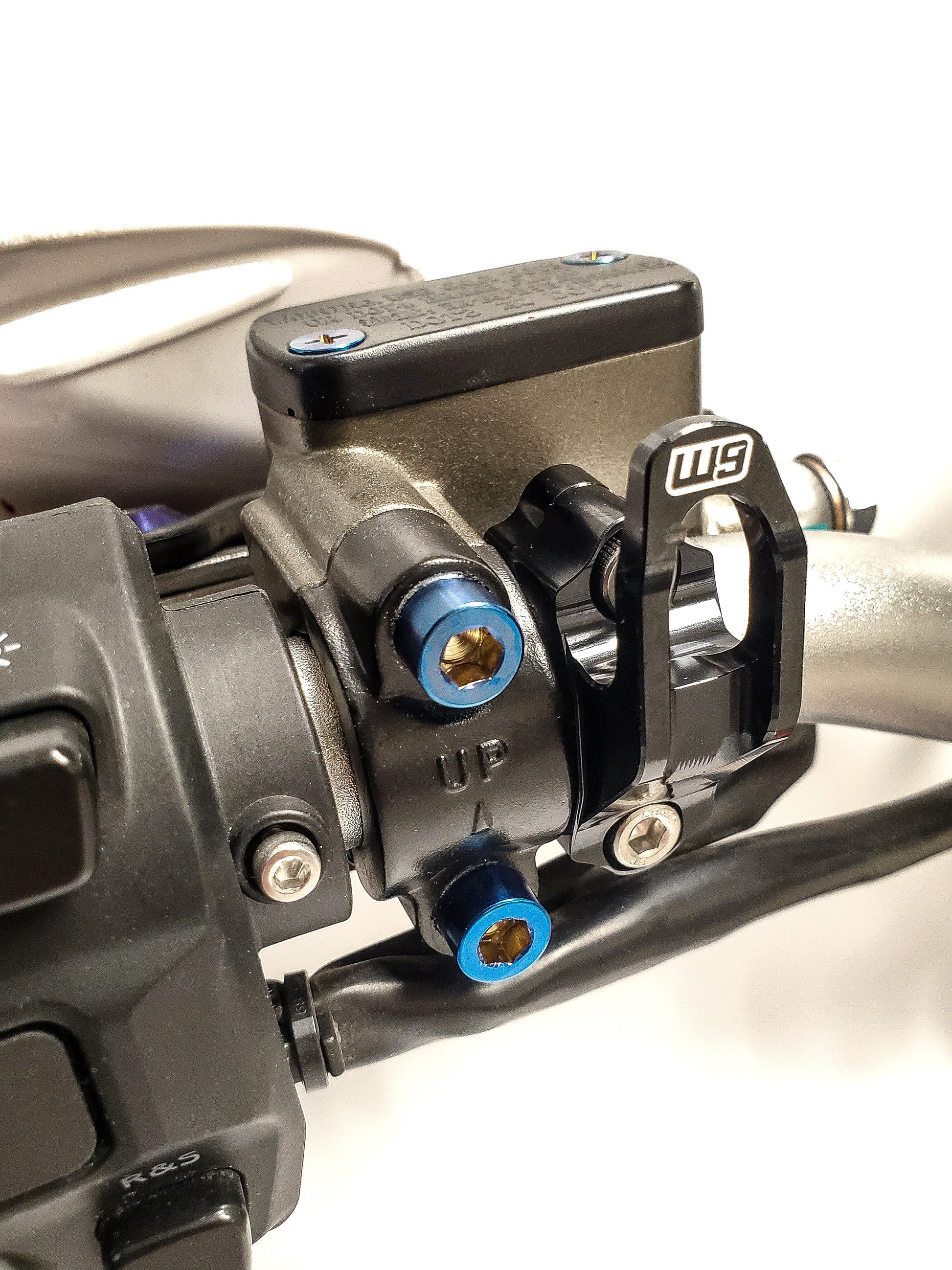 Warp9Racing helmet hook mounted on wall, sturdy metal motorcycle gear storage accessory for helmets.