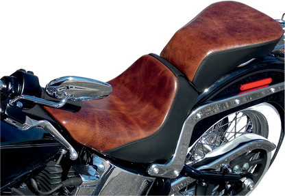 Bill's Exhausts SADDLEMEN Lariat Seat for FLSTN/C motorcycle, showing black leather seat with detailed stitching and contoured design.