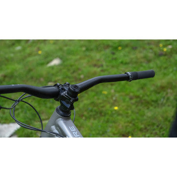 Bill's Exhausts phone mount from SP CONNECT 52820, securely attached to a motorcycle handlebar for easy device access.