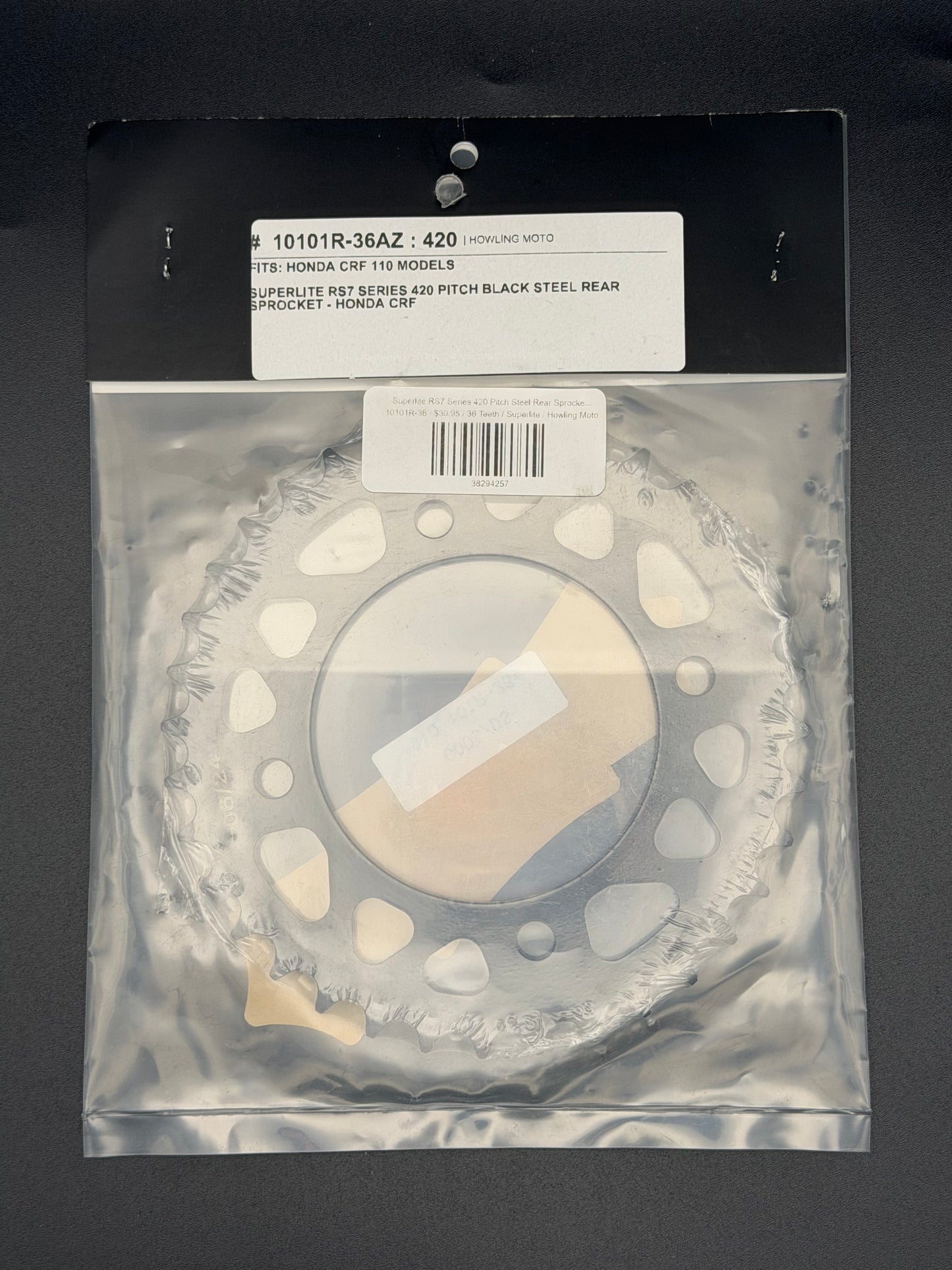 Superlite RS7 Series 420 pitch steel rear sprocket for Honda CRF110 motorcycle, showing the sprocket's teeth and metallic finish.