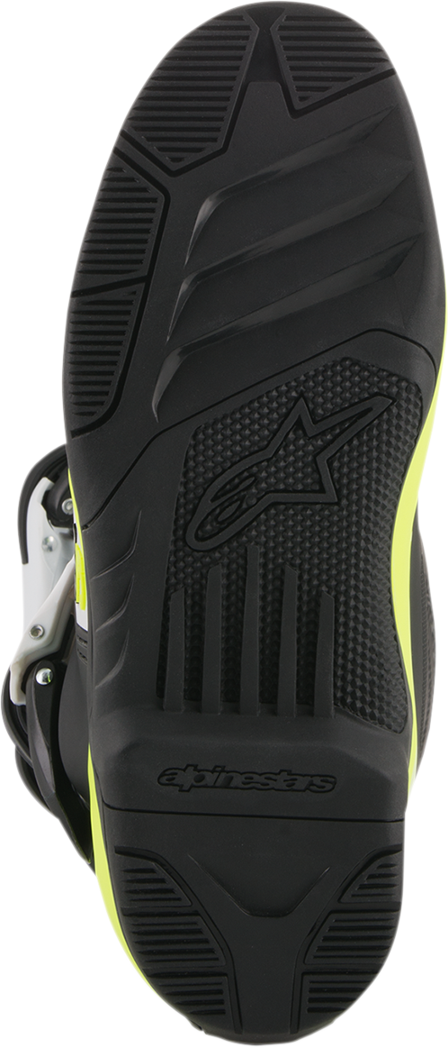 Alpinestars Tech 3S motorcycle boots in black, white, and fluorescent yellow with sturdy design and adjustable straps.